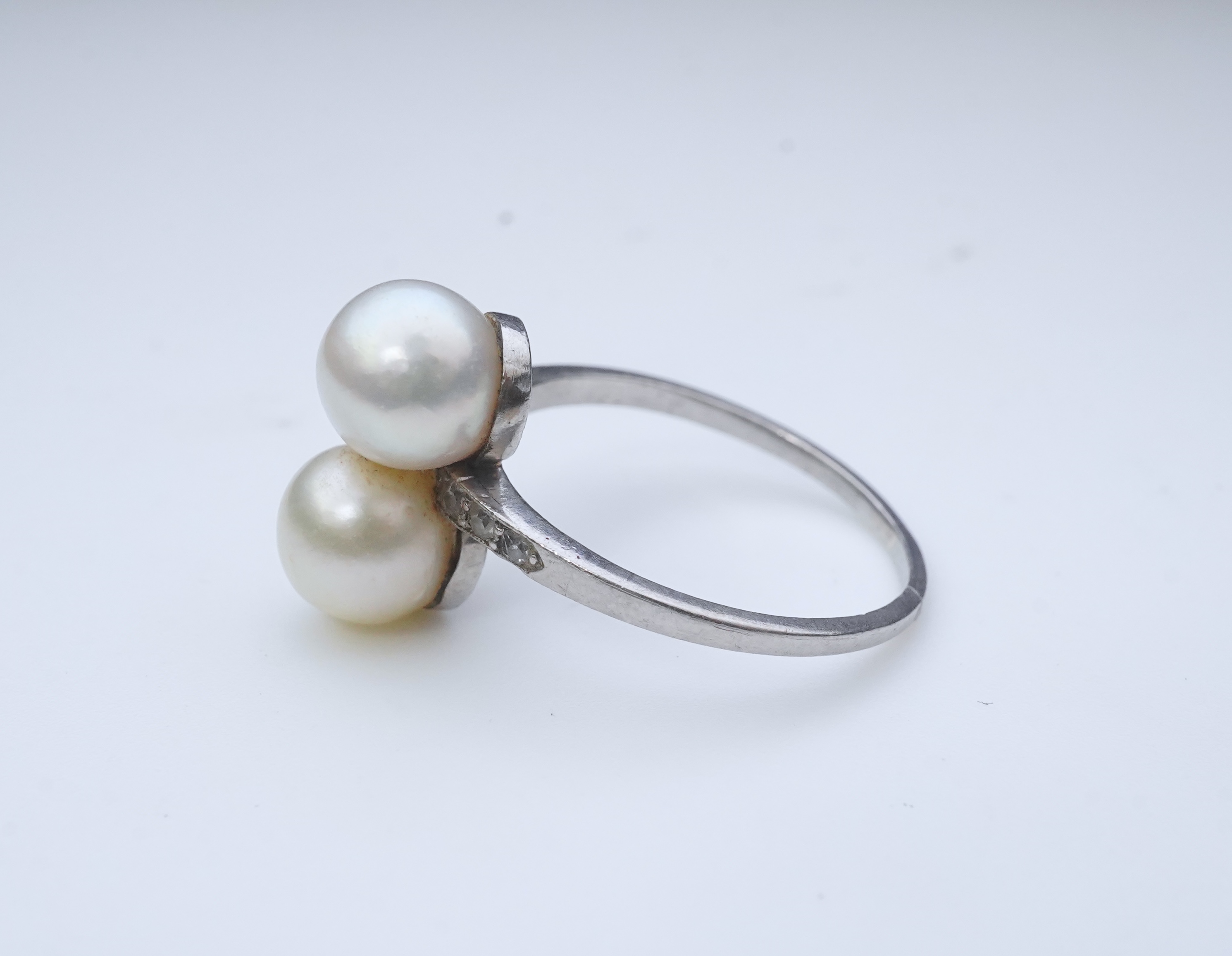 A pearl and diamond toi-et-moi ring, circa 1920